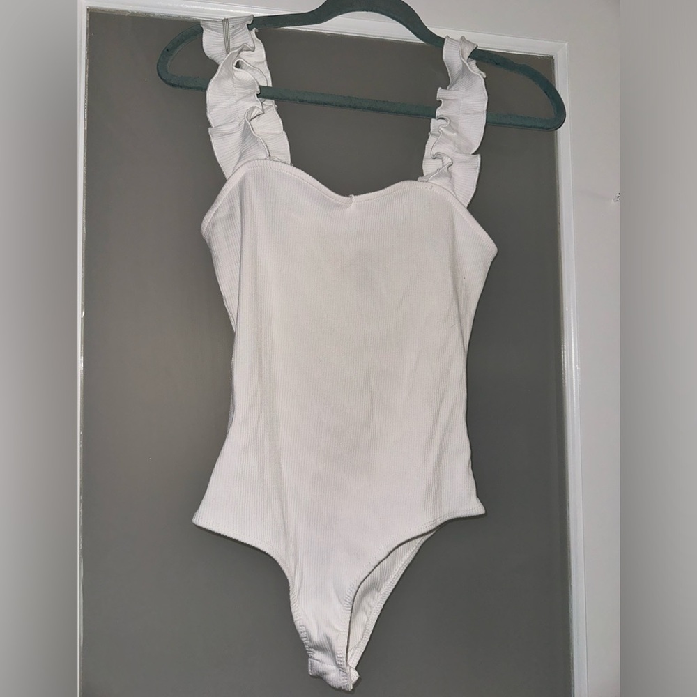 white bodysuit with ruffled straps